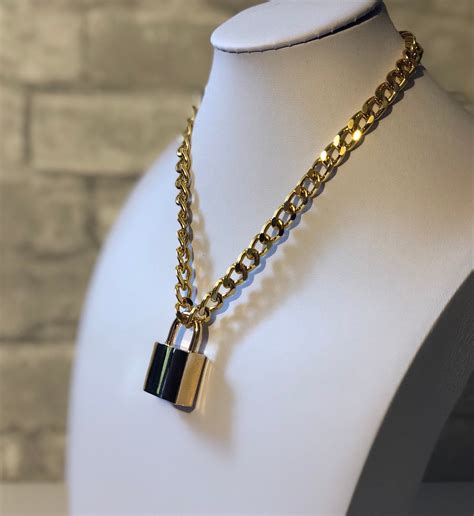 chain necklace with padlock pendant.